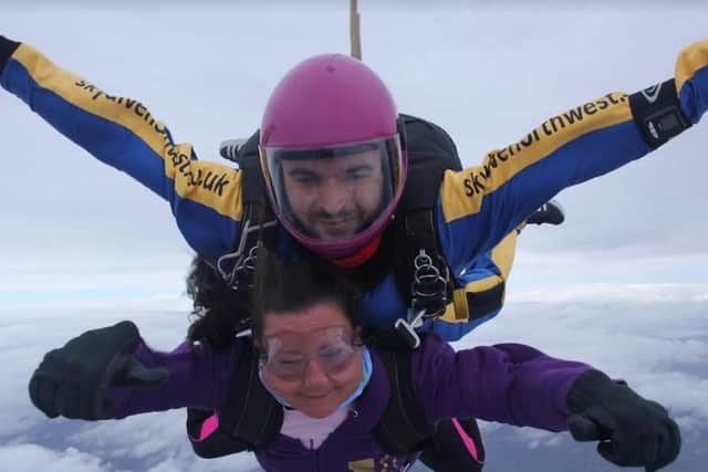 Heather conquers her fear in a sky dive with instructor Paul in aid of cancer research.