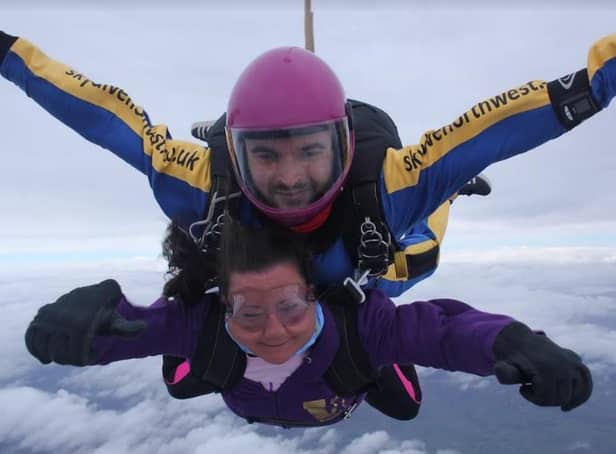 Heather conquers her fear in a sky dive with instructor Paul in aid of cancer research.