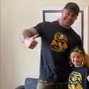 Jordan, 9, with his dad Matt Banks, pictured wearing their Cobra Kai t-shirts together