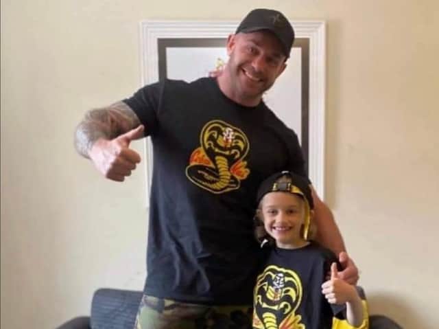 Jordan, 9, with his dad Matt Banks, pictured wearing their Cobra Kai t-shirts together