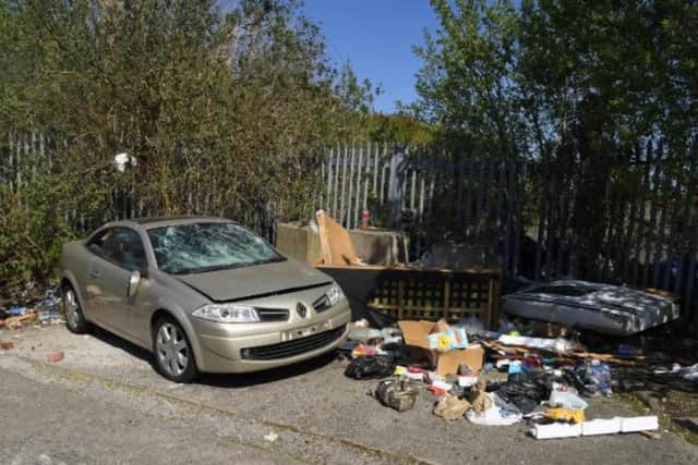 Rubbish dumped in Southlands, Preston, including an abandoned car.