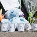 Candle holders with the name George spelled out across them were left in Mallowdale Avenue.