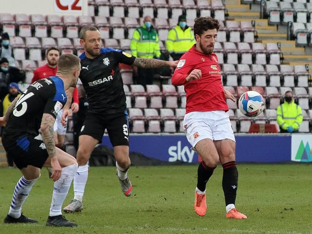 Jay Spearing (challenging Cole Stockton) has had his say on Morecambe's play-off semi-final with Tranmere Rovers