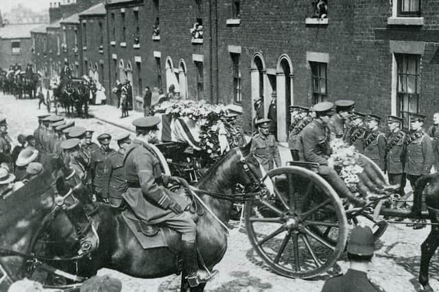 Pte William Young VC' coffin, covered with a Union Jack and borne on a gun carriage, leaves the family home