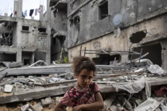 Ten-year-old Rahaf Nuseir in front of her family's bombed out home when they returned to the town of Beit Hanoun today after the ceasefire.