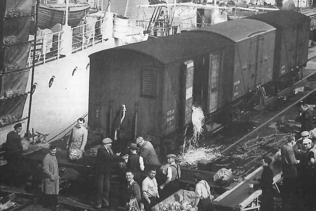 Unloading bananas by conveyor belt into railway wagons on the south side of Preston dock circa 1960