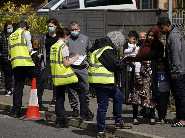 People queuing for Covid vaccinations at the ESSA academy in Bolton as the spread of the Indian coronavirus variant could lead to the return of local lockdowns
