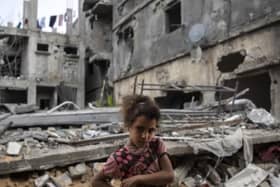 Ten-year-old Rahaf Nuseir outside the ruins of her family home in Gaza.