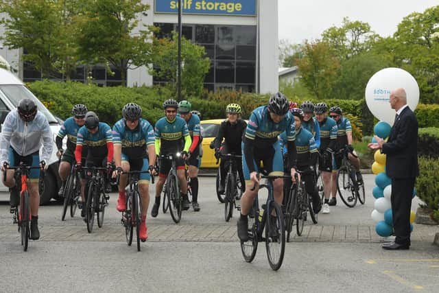 Just 340 miles to go! Edwin Booth  applauds the cyclists as they set off from the Booths Head Office in Ribbleton   Photo: Neil Cross