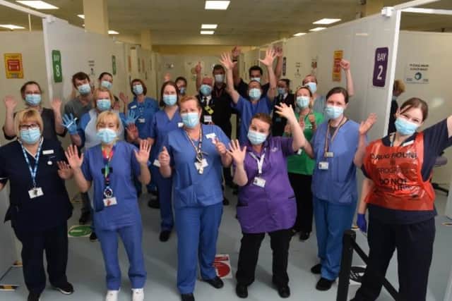 Staff at the vaccination unit in Preston's St John's Shopping Centre celebrate Lancashire passing the one million jab mark.
