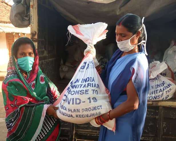 Women receives food kit in Odisha state
