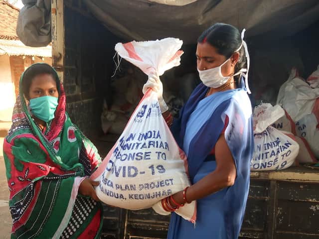 Women receives food kit in Odisha state