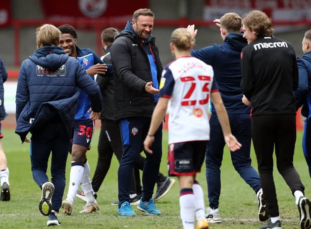 Ian Evatt, centre, celebrates Bolton's promotion with his players