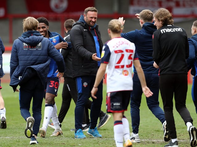 Ian Evatt, centre, celebrates Bolton's promotion with his players