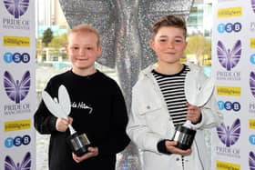 Inspirational best friends Hughie Higginson and Freddie Xavi with their Pride of Manchester trophies