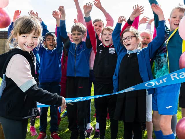 Frankie Garbett cuts the ribbon to get the Race For Life events at St Laurence CE Primary School, Chorley, started