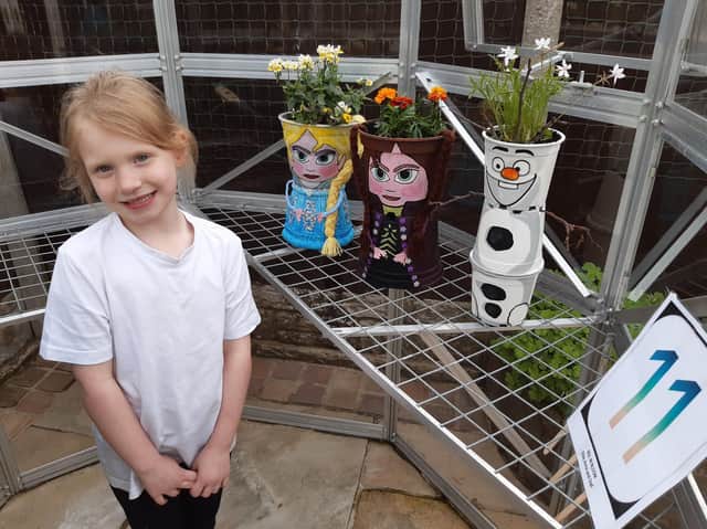 Pupil Cadence Cockburn, with three of the 59 plant pots in the fund-raising trail which is raising money for Brindle Gregson Lane Primary School