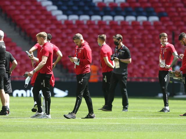 Morecambe players inspect the Wembley pitch