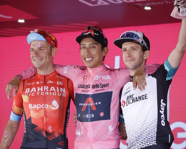 Colombia's Egan Bernal is flanked by runner-up Italy's Damiano Caruso, and Third placed Britain's Simon Yates, right, as he celebrates on podium after completing the final stage to win the Giro d'Italia cycling race, in Milan, Italy.