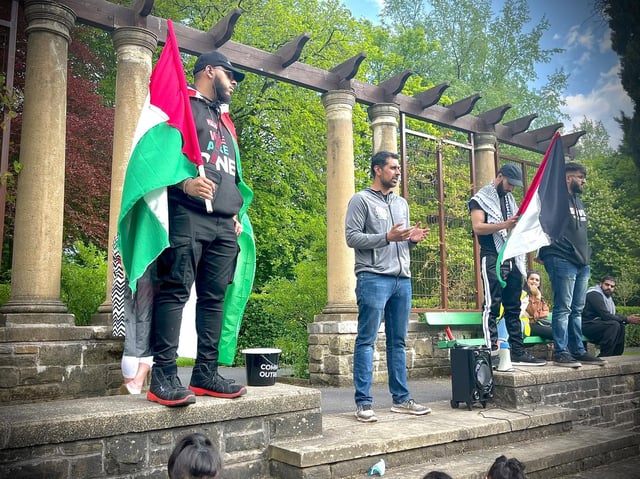 Local protestors bearing the Palestinian flag gather at Thompson Park in Burnley