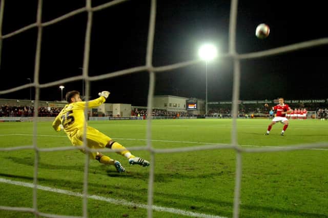 Morecambe's Lewis Alessandra puts his penalty over the bar as PNE keeper Andreas Arestidou dives to his left