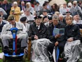 Veterans watch the official opening of the British Normandy Memorial in France via a live feed during a ceremony at the National Memorial Arboretum in Alrewas, Staffordshire