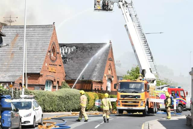 Fire crews using an aerial ladder platform to extinguish the flames.