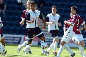 Preston North End winger Simon Whaley evades the attention of the Hearts defence to score at Deepdale in July 2006