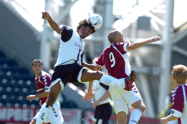 PNE defender Youl Mawene competes in the air with Hearts striker Roman Bednar