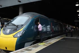 A man looks through the window of an Avanti West Coast Class 390 EMU train before it departs from London Euston for Glasgow Central Station on an attempt to break the 36-year-old record