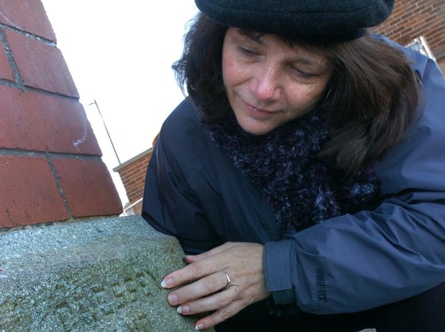 Pamela Cressey from California find her grandfather's name on Morecambe's clock tower, which he helped design.