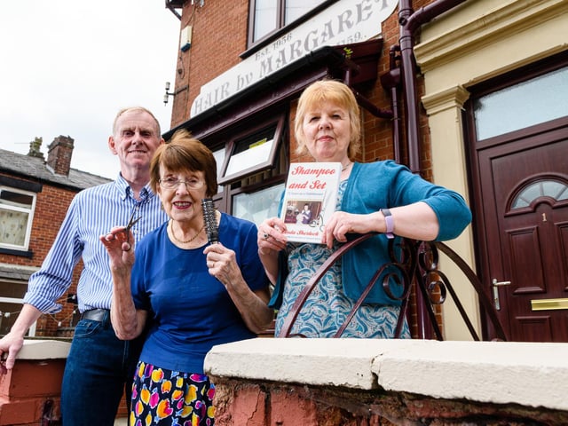 Margaret, pictured outside her salon with children Adrian and Linda celebrating the publication of her biography. Photo: Kelvin Stuttard
