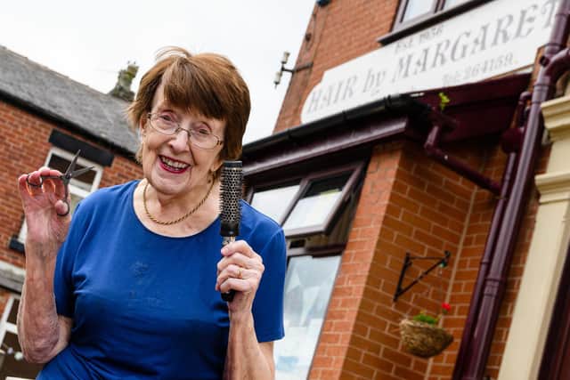 Margaret pictures outside her salon, happy to be hairdressing at 91. Photo: Kelvin Stuttard