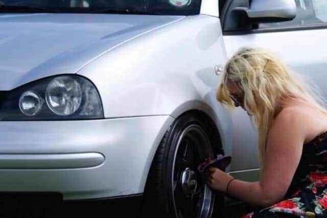 Olivia working on her car as a 17-year-old