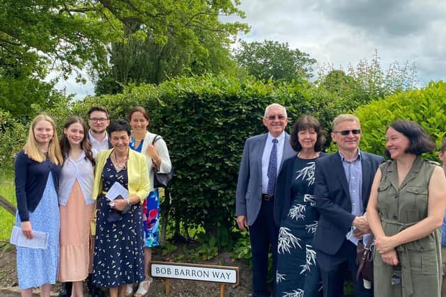 Remembered with love  and with  gratitude for his parish work.  Bob Barron's wife Moira, daughters Louise and Lucy, son-in-law Peter and grandchildren Luke, Mary and Helena  are pictured  with Mike and Bridget Bryan at the naming ceremony.