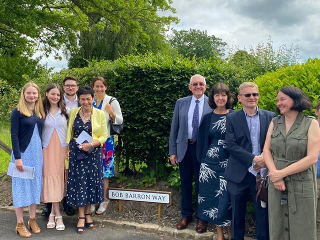 Remembered with love and with gratitude for his parish work. Bob Barron's wife Moira, daughters Louise and Lucy, son-in-law Peter and grandchildren Luke, Mary and Helena are pictured with Mike and Bridget Bryan at the naming ceremony.