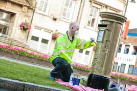 The moment a post box is painted gold in Chorley as a 2012 tribute to Sir Bradley Wiggins' Olympic glory