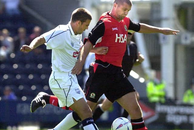 PNE striker David Healy challenges Blackburn defender Dominic Matteo at Deepdale