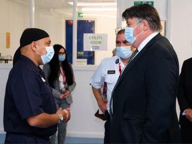 Minister Lord Greenhalgh chats with Faz Patel from the Lancashire Fire and Rescue Service.