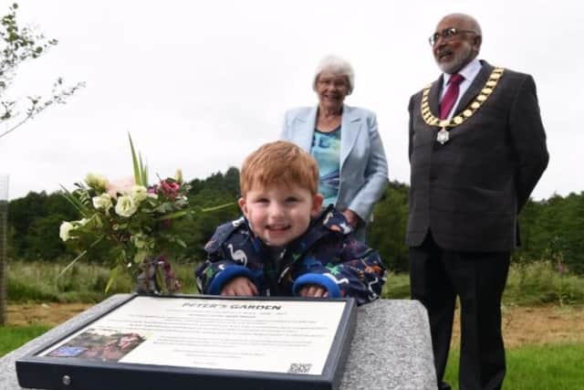 Great grandson Finley, two, at the unveiling of the memorial garden with Peter's widow Nora and Preston Mayor Coun Javed Iqbal.