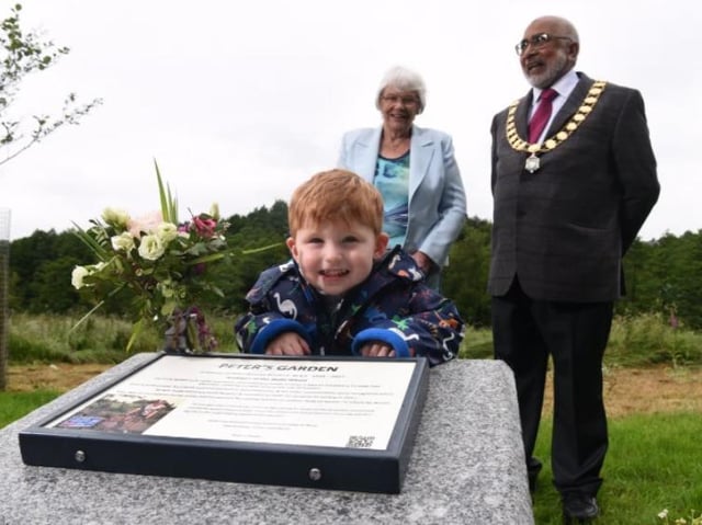 Great grandson Finley, two, at the unveiling of the memorial garden with Peter's widow Nora and Preston Mayor Coun Javed Iqbal.