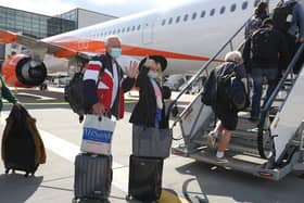 Passengers prepare to board an easyJet flight to Faro, Portugal, at Gatwick Airport