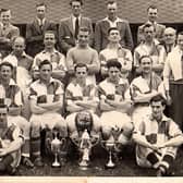 Photograph of Caton United 1948-1949 at Jowett’s Field, Caton, with a clean sweep of  trophies won in that season, Division1 title, Parkinson Cup & Senior Challenge Cup.Back row from left: Dick Woolcock, George Wilson, Stanley Walker, Bill Dainty, George Robinson. Middle row from left: Tom Eglin, Bill Hodgson, Jimmy Till, Jimmy Clarkson, Bert Cartmel, Albert Robinson, R. Bowker, Ritson Stockdale, Sid Southward 
Front row from left: Fred Robinson, Joe Easterby, Jock Kerr (captain), Ted Fairclough, Cyril Gardner. Sat on the ground from left: Jimmy Mason, Frank Woodhouse.