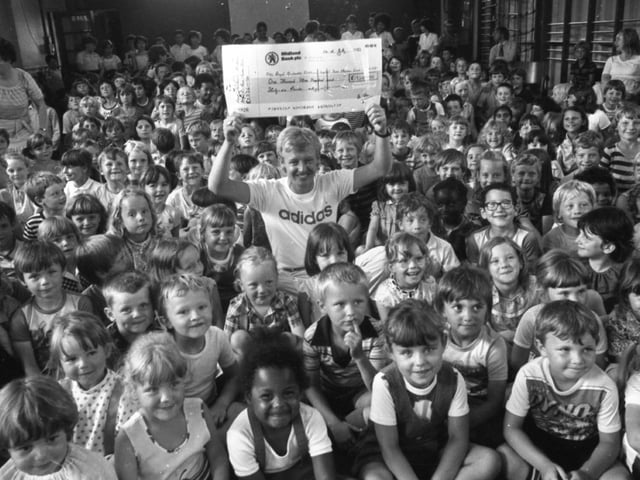 A hush-marathon by a bunch of schoolkids will help to boost the long fight against a killer disease. For around 300 children at Greenlands Primary School, Ribbleton, Preston, raised more than £1,300 for the fight against leukaemia, by holding a sponsored silence. And to put a smile on everyone's face when the cheque was handed over was comedian Les Dennis, who is starring in Blackpool. He is pictured holding the cheque which he received on behalf of the Manchester Children's Hospital Bone Marrow Transplant fund