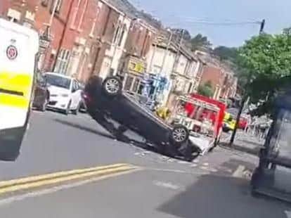 A man was taken to hospital after a car flipped onto its roof in Preston. (Credit: Izy Ahmed)