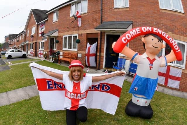 England flans wave down the street as front gardens are decorated with bunting and inflatables