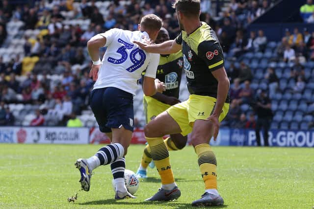 Billy Bodin goes past a Southampton defender in the build-up to scoring at Deepdale in July 2019