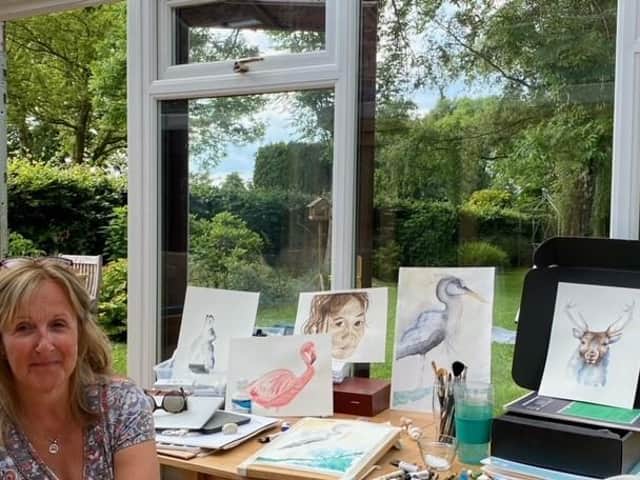 Frances Hamer with some of her paintings