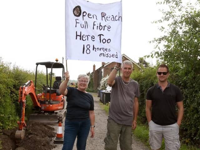 Photo Neil Cross; Barbara and Richard Farbon with Gavin Hughes protesting against Open Reach in Bretherton
