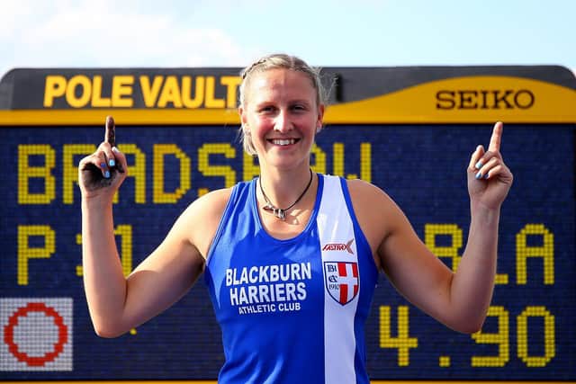 Holly poses for photographs after setting the new national record at Manchester Regional Arena